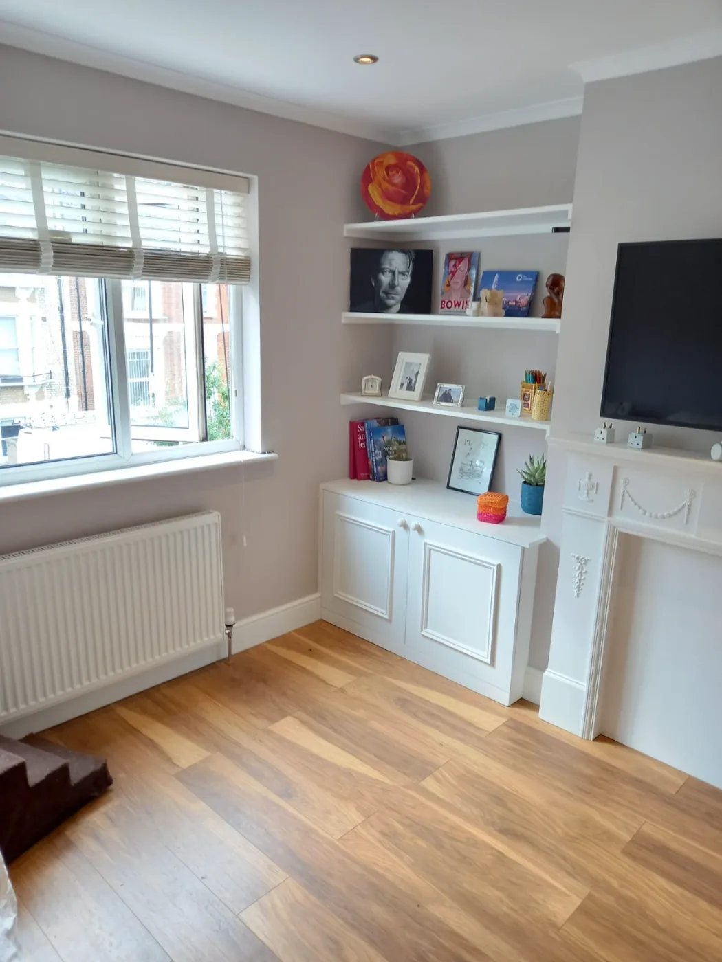 Living room with shelves, cabinets and wood floors cleaned